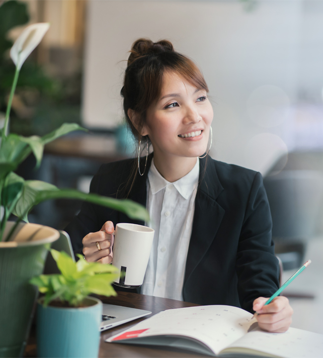 Woman in office holding a cup